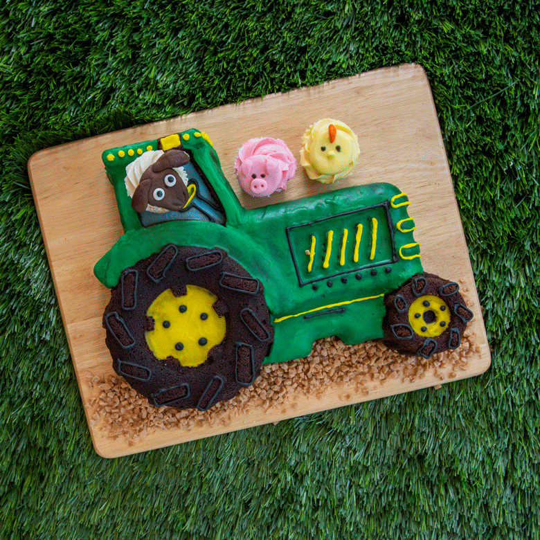 Moving GIF- baked tractor cake with "moving" animal cupcakes in scene