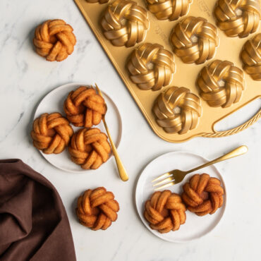 plain mini bundts on white serving plates made with Nordic Ware aluminum braided mini bundt pan