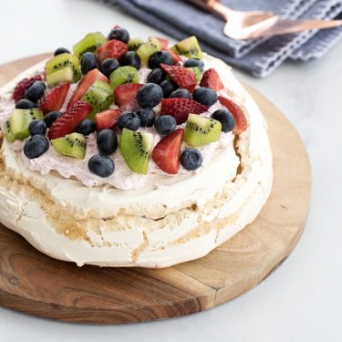 Mixed Berry and Kiwi Pavlova with Strawberry Whipped Cream