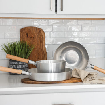 Naturals cookware collection in kitchen, cutting board in background