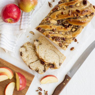 Apple braided loaf overhead with a few pieces cut