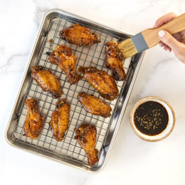 Naturals® Quarter Sheet with Oven-Safe Nonstick Grid with chicken wings.
