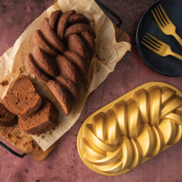 Golden braided loaf cake baked in Nordic Ware aluminum braided loaf pan, showing detailed rope pattern