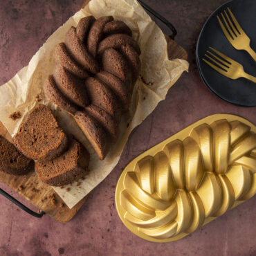 Baked 75th Anniversary Braided Loaf cake next to the Bundt pan.