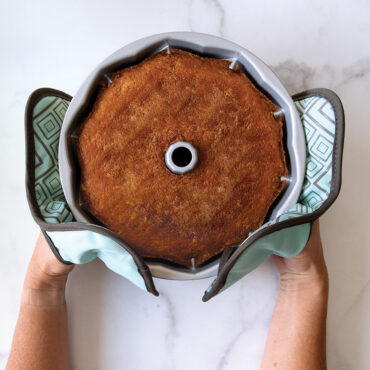 Hot Pads holding Bundt Pan with Baked Cake