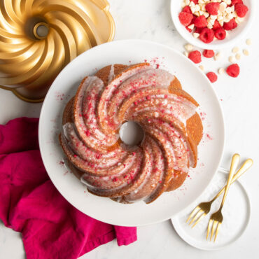 Golden swirl bundt cake with white glaze, baked in Nordic Ware aluminum bundt pan
