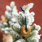Hanging gold Heritage Bundt ornament on white Christmas tree
