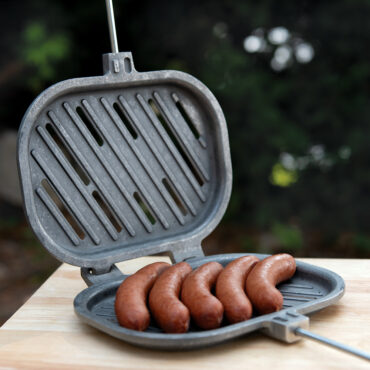 Campfire griller open with sausages