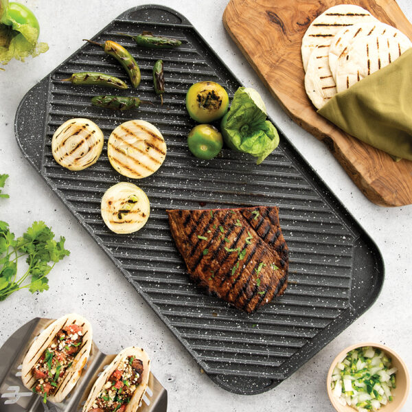A overhead image of making steak tacos on the grill side of the reversible griddle.