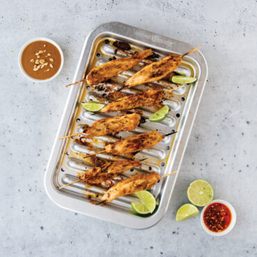 kabobs on Nordic Ware natural aluminum broiler pan with slotted rack, roasted vegetables and meat visible