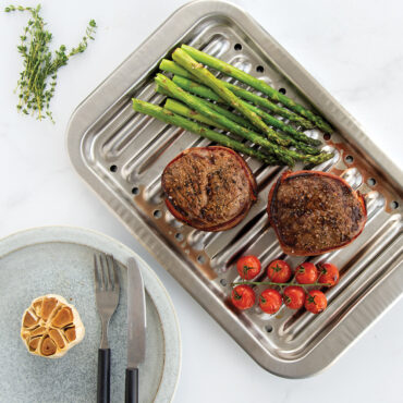 Overhead image of a natural aluminum broiler pan roasting vegetables, broiling meats, and making delicious baked goods.
