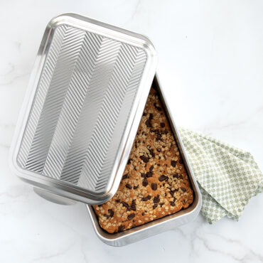 Chocolate chip cookie bars in pan with embossed lid