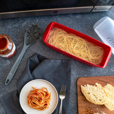 Spaghetti being made with the microwave pasta maker