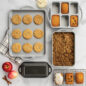 ProCast Every Day Bakeware product shot on marble background with fall baked treats such as cookies, apple crisp and mini loaf cakes.