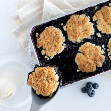 Dishing up berry cobbler with spatula baked in Procast 7" x 11" Baking Pan