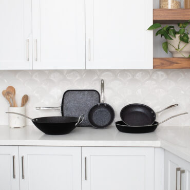 A group image of the Basalt Ceramic Cookware Line in a white kitchen.
