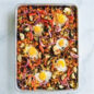 a sheet pan meal including eggs, bell peppers, onions, and more vegetables using the baker's half sheet