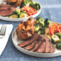 an image of 2 meal plates with steak and vegetables on the plate.