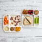 overhead image of kids snack and dinner meals on two divided meal trays