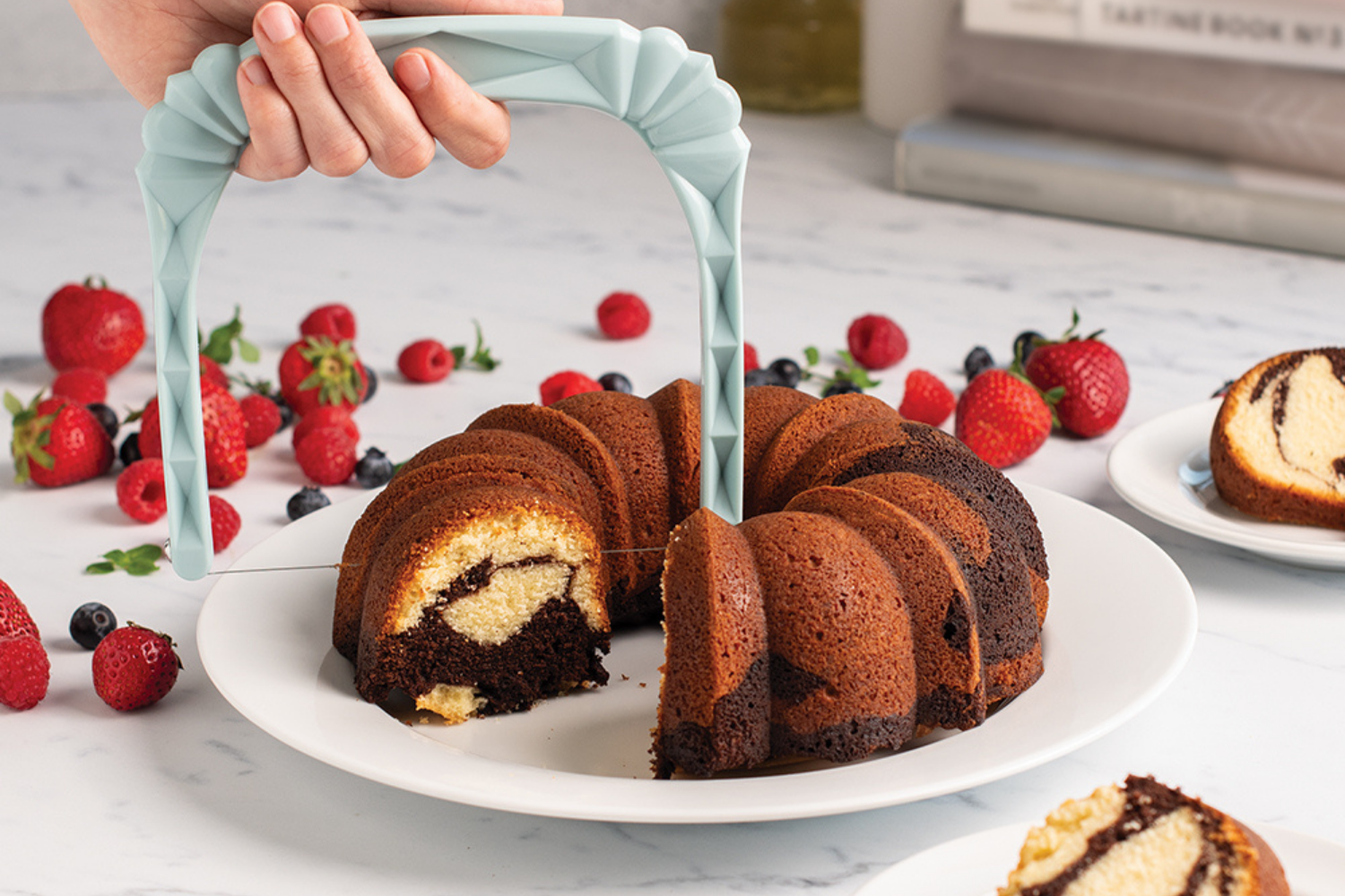 Bundt Slicer cutting a piece out of an original Bundt cake. 