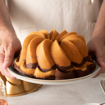 Pirouette Bundt Pan hands holding baked bundt cake