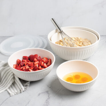 Nordic Ware 8 piece white bowl set including 7, 5, 3.5 and 2 quart bowls filled with baking ingredients