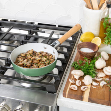 Nordic Ware 8-inch ceramic nonstick skillet in cardamom color with sautéed mushrooms on stovetop