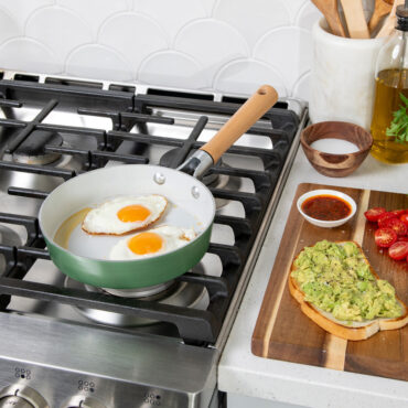 Nordic Ware 8-inch cardamom ceramic nonstick skillet on stovetop with scrambled eggs cooking