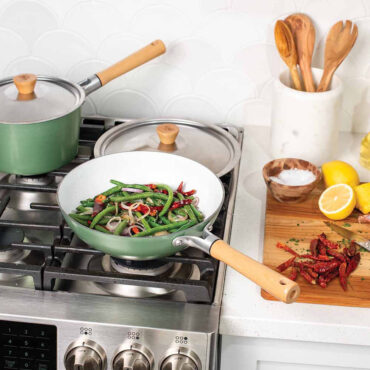 Image of 10in Cardamom NS Wok on stovetop with veggies