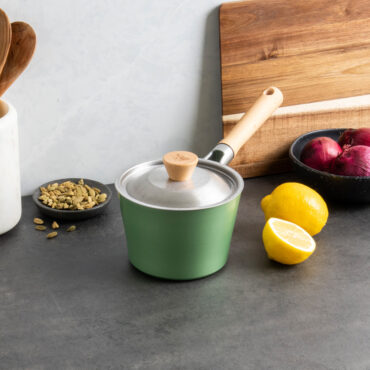 Image of Cardamom 1.5Qt Saucepan + Lid displayed on countertop with ingredients and utensils
