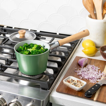 Cardamom 1.5Qt Saucepan with broccoli in pan on stovetop, lid in background