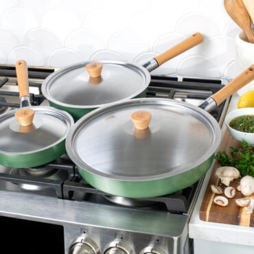 Cardamom 6 piece fry pan and lid set on stove top, pans covered by lids