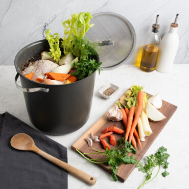 Verde 12 Qt Stockpot with Lid on countertop with veggies