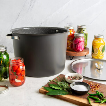 20 Qt Stock Pot with lid displayed with various jars of vegetables