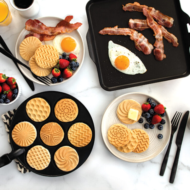 Image of Geo Pancakes pan with cooked pancakes and griddle with savory food on it.