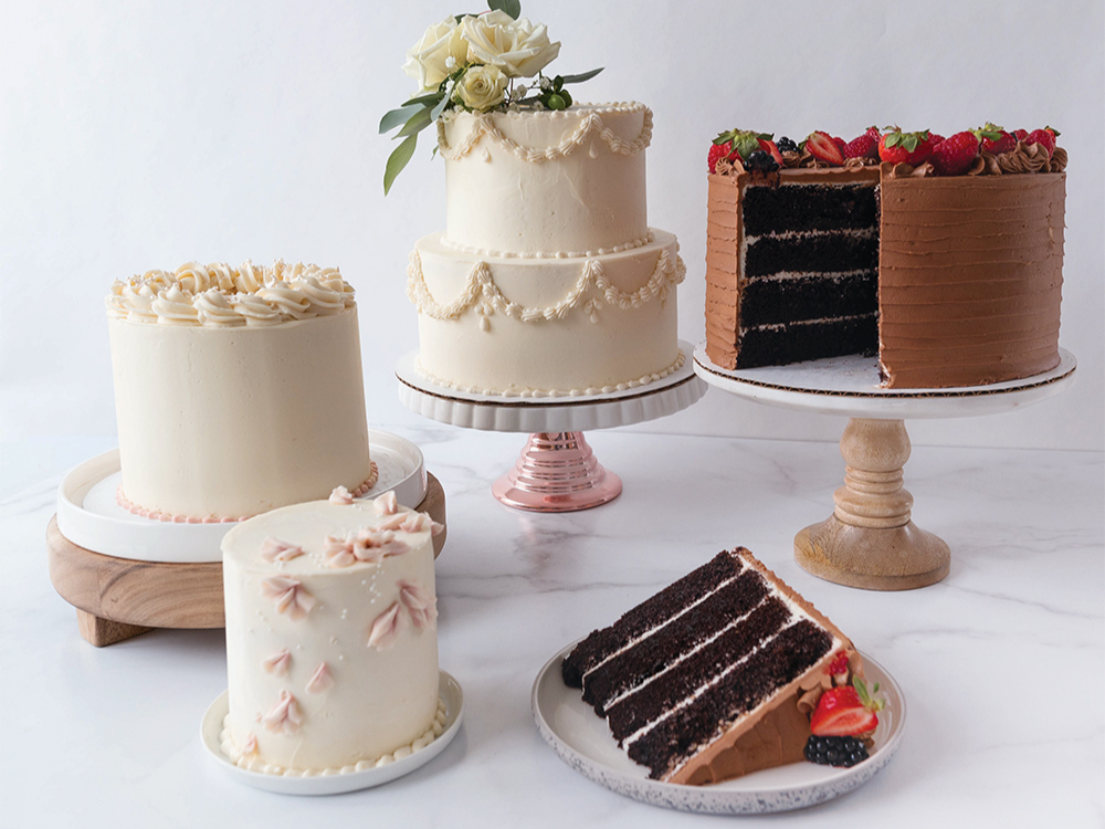 Collection of beautifully decorated layered chocolate and vanilla cakes. 
