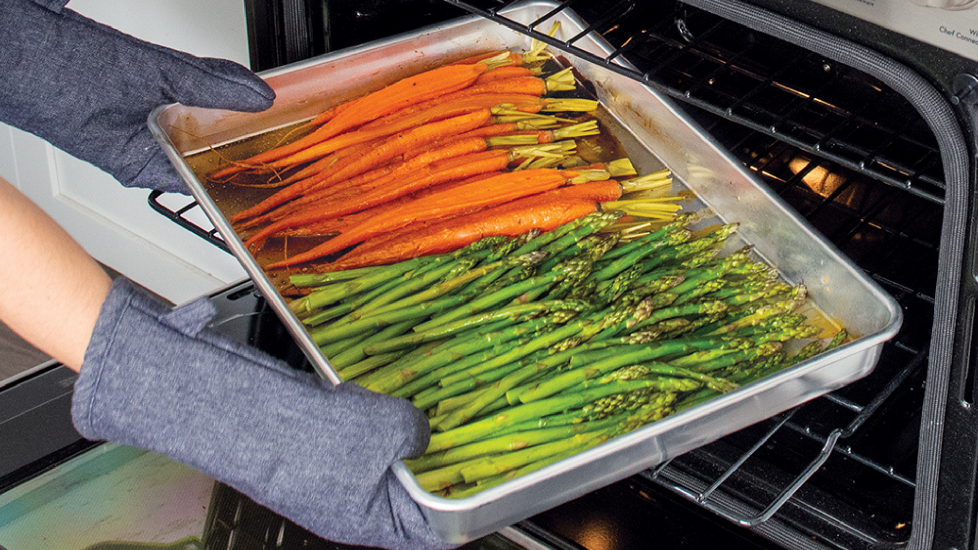 Roasted carrots and asparagus in a Naturals® High Sided Sheetcake Pan. 