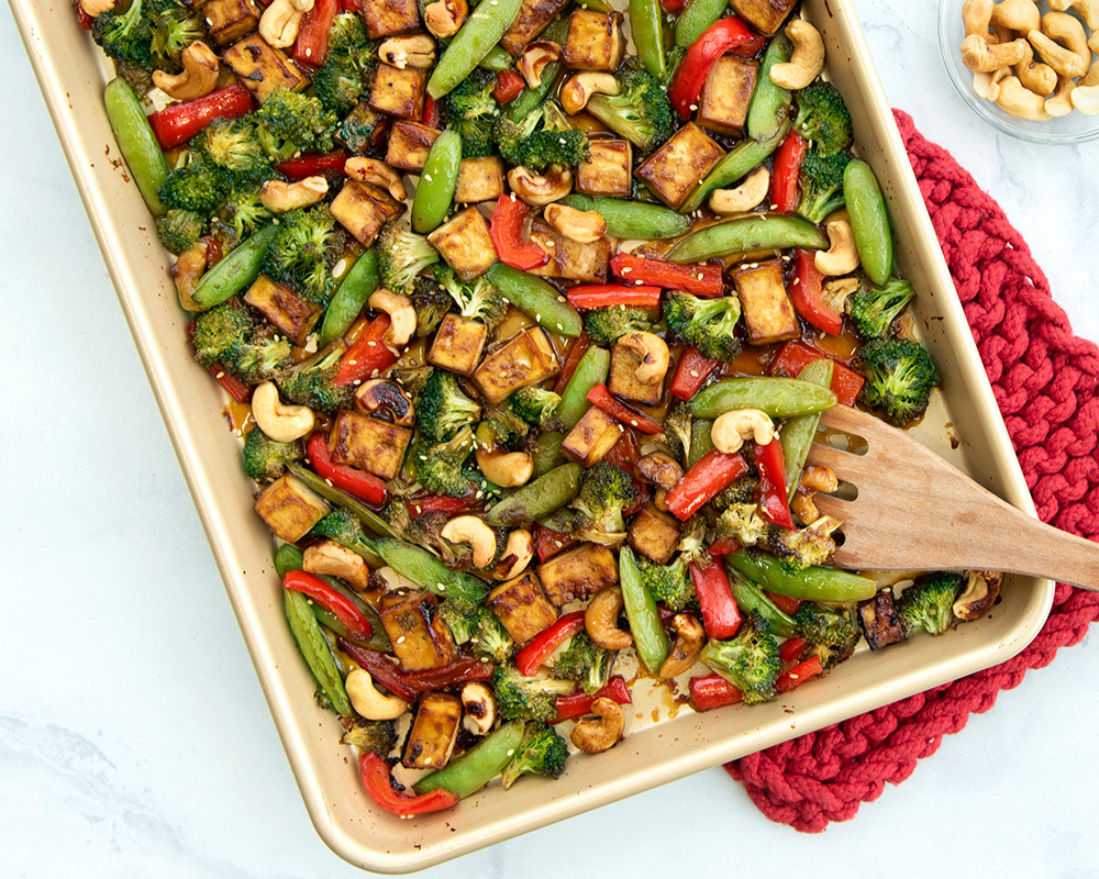 Roasted vegetables and tofu on a Naturals® Nonstick Baker's Half Sheet. 