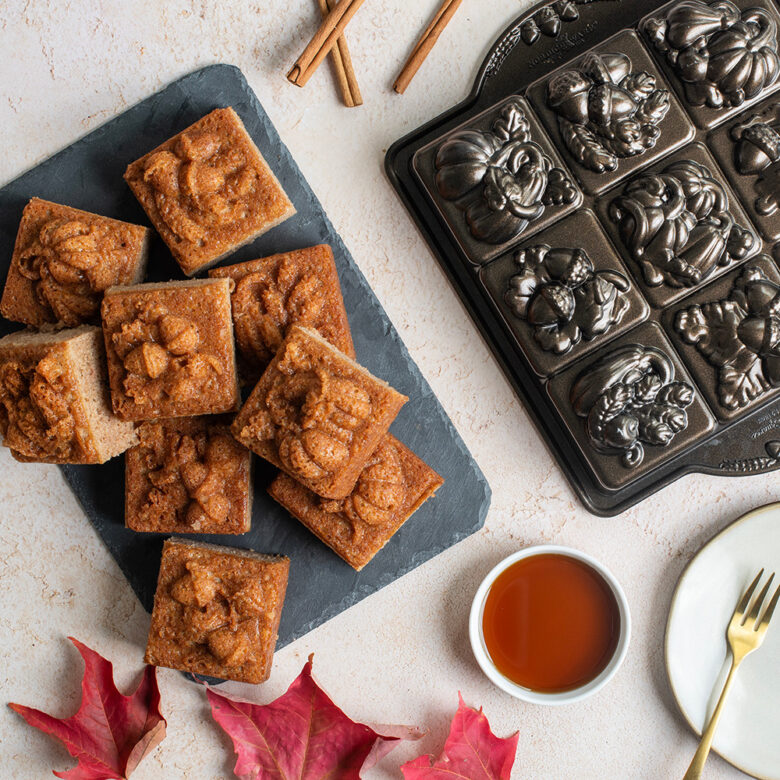  Image of baked brown butter maple coffee cake squares with Fall design on top.