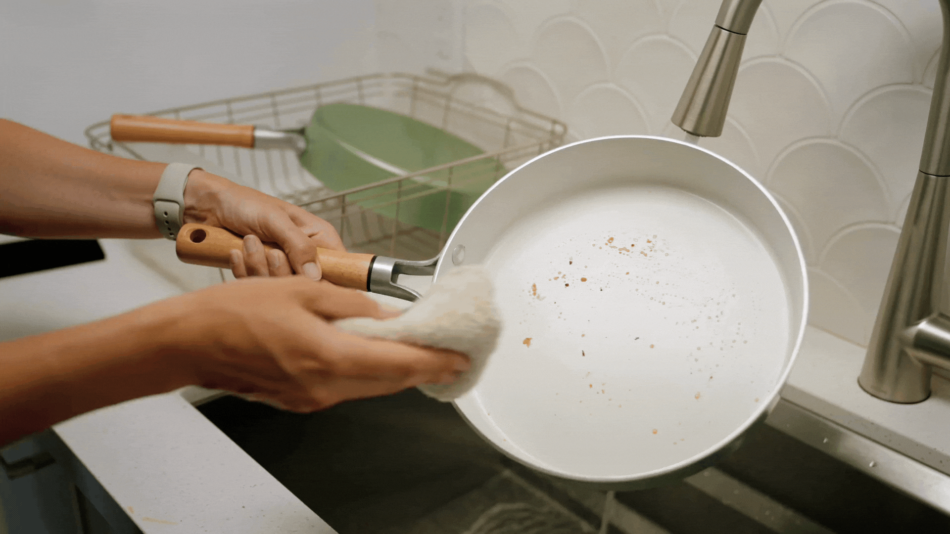 Gif of easily cleaning a Cardamom Nonstick Frying Pan with a rag in the sink. 