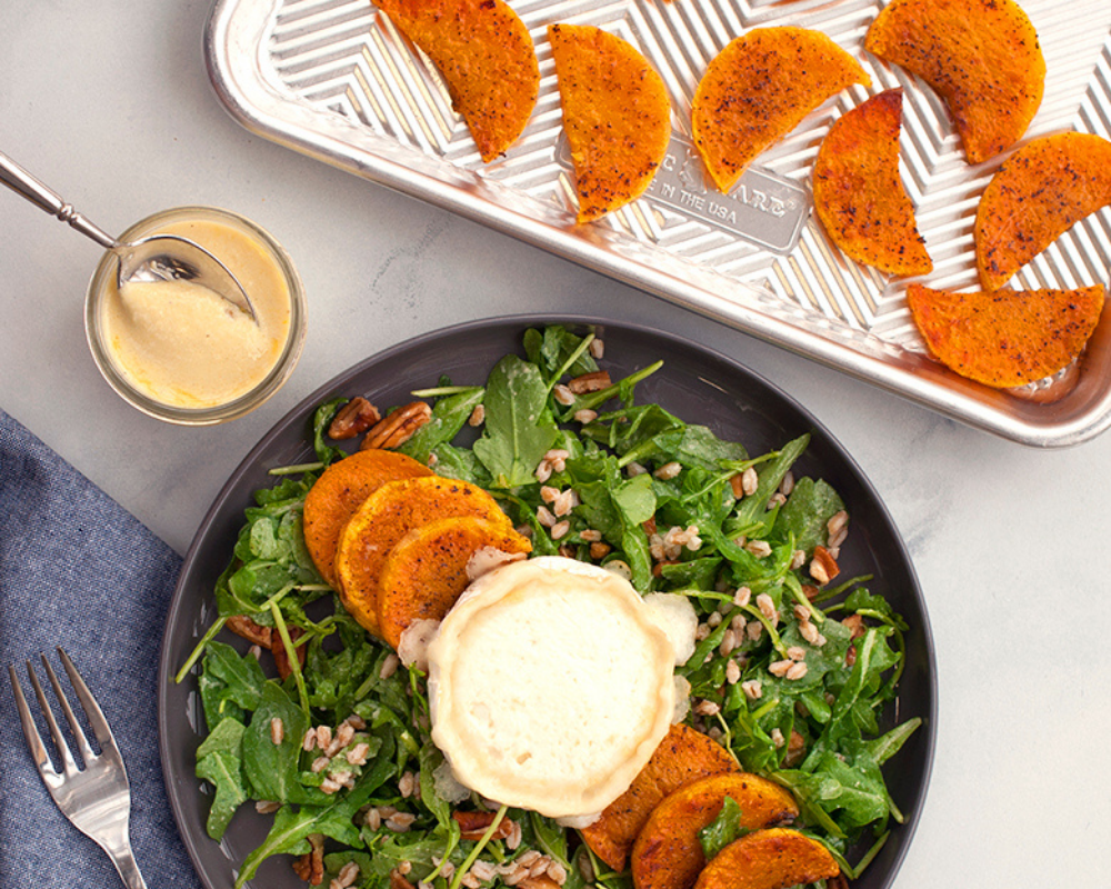 Butternut squash cooked on a Prism Baking Sheet then added to a salad with dressing on the side. 