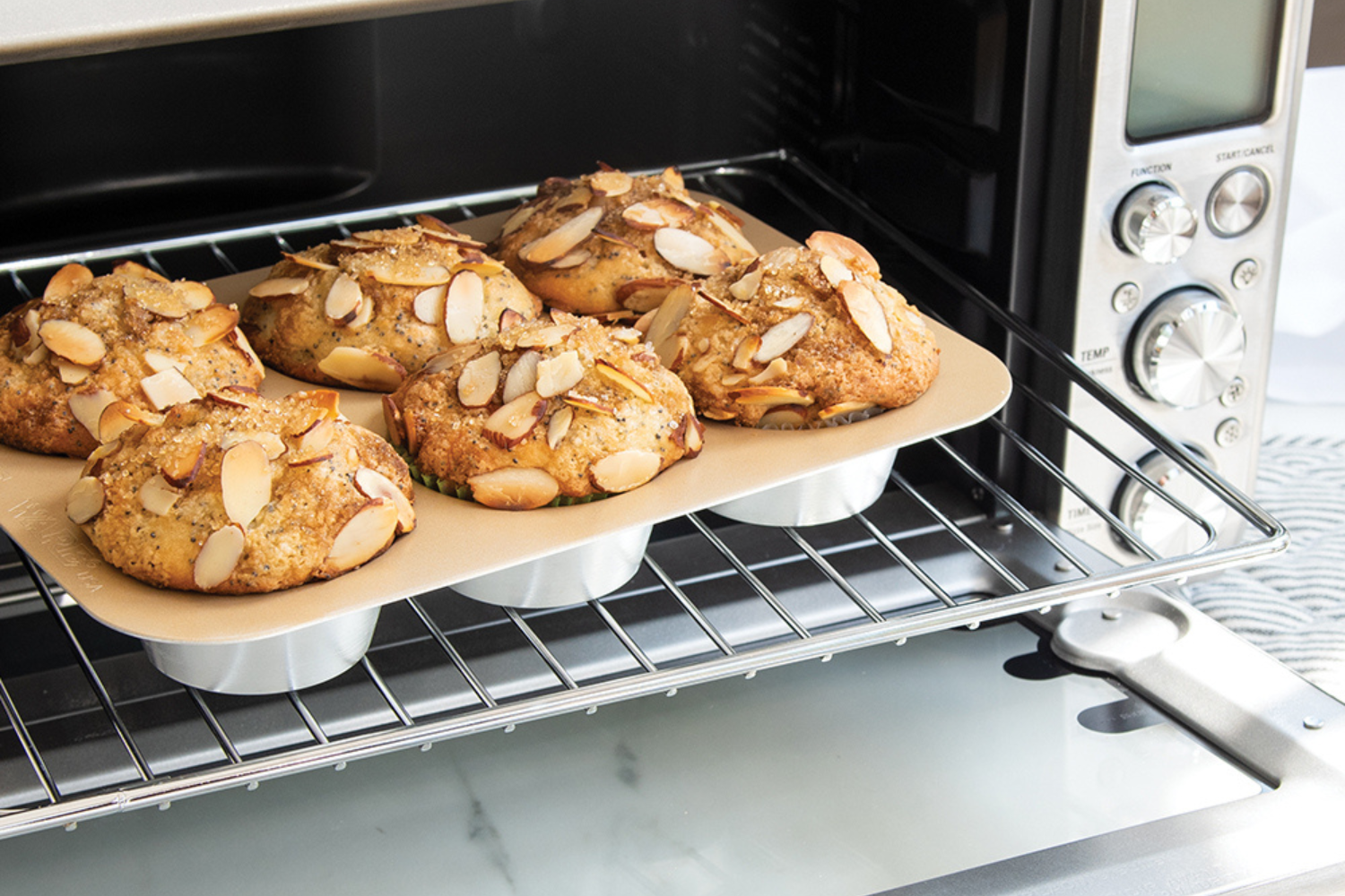 Lemon Poppy Seed Muffins Lemon Poppy Seed Muffins coming out of a toaster oven in a Nonstick Compact Ovenware Muffin Pan