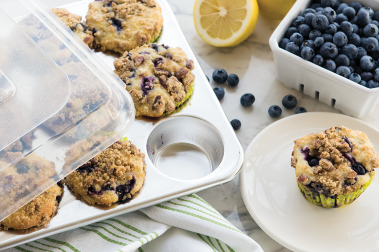 Lemon Pecan Blueberry Muffins Lemon Pecan Blueberry Muffins in a Naturals® 12 Cavity Muffin Pan with one served on a white plate.
