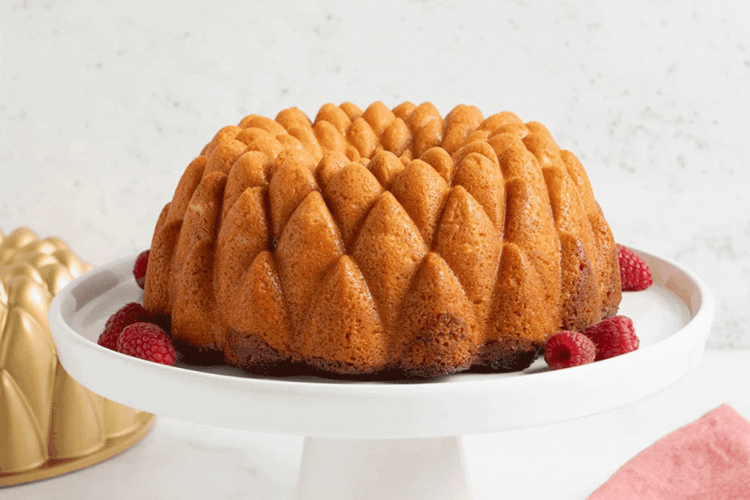 Glazing Almond Kaleidoscope Bundt® with Raspberry Swirl Glazing a Kaleidoscope Bundt® Cake