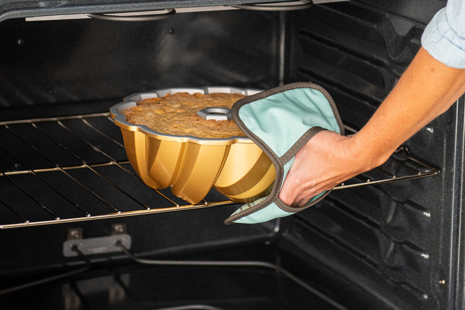 75th Anniversary Braided Bundt® Pan In Oven 75th Anniversary Braided Bundt® Pan being taken out of the oven.