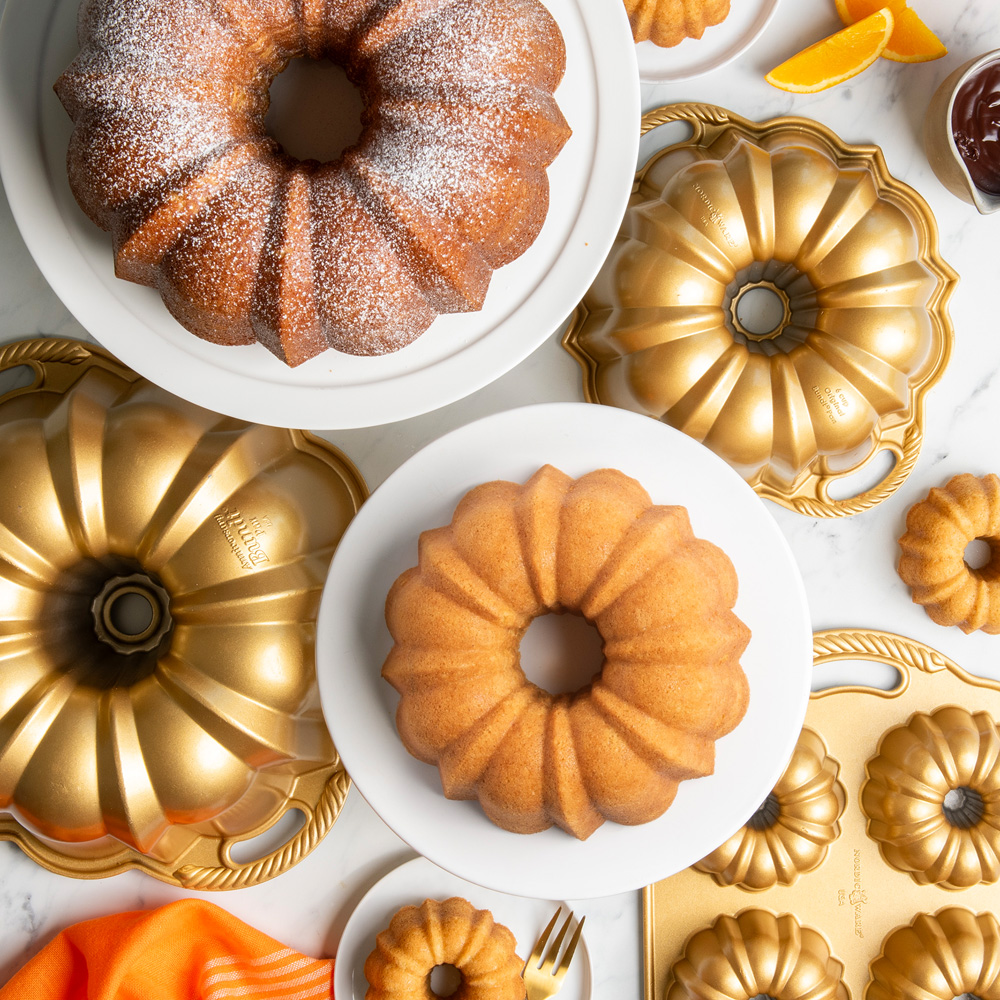 Image of Bundt cakes and Bundt Pans in different sizes with ingredients on surface
