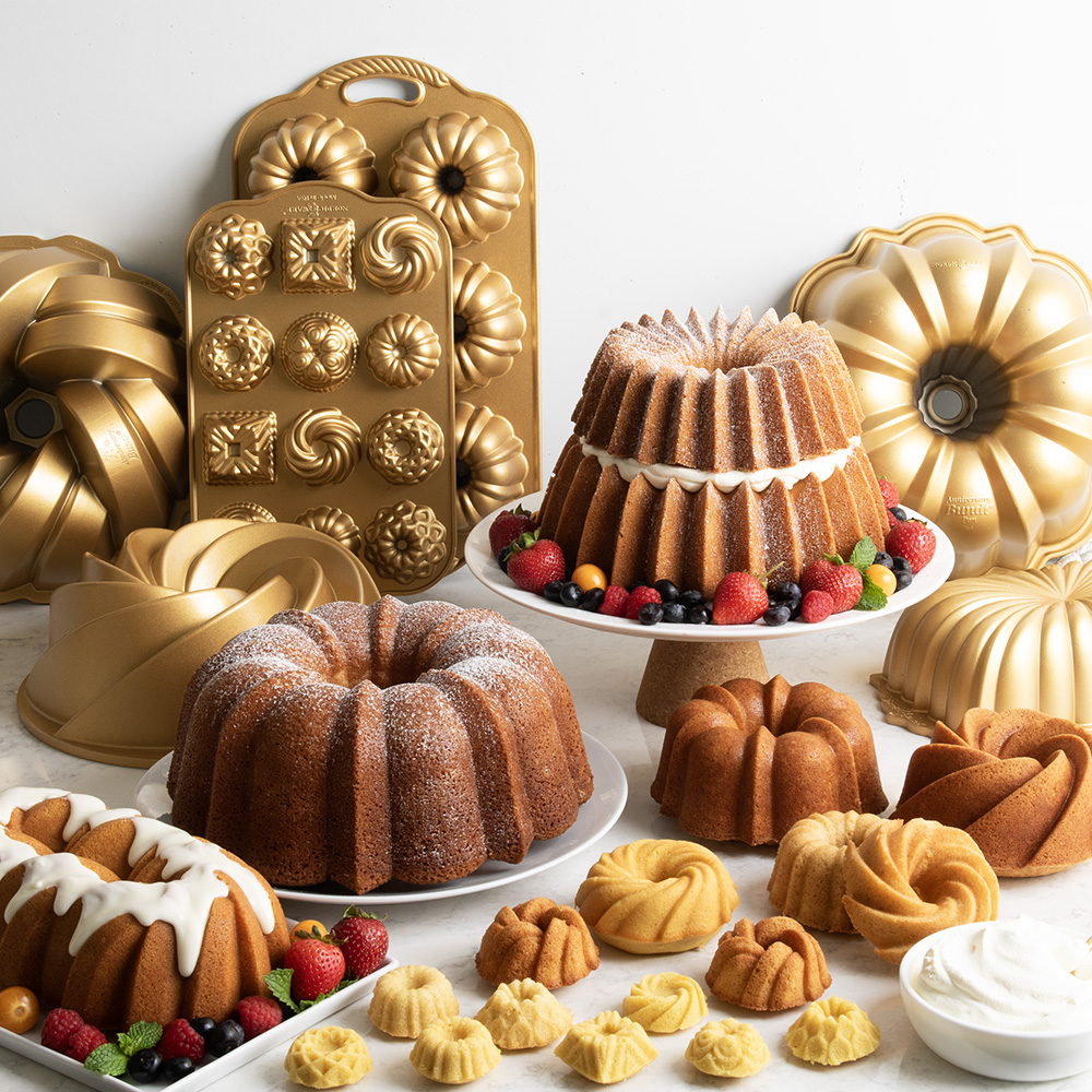 Image of a kitchen table with different size Bundt cakes and Bundt Pans in a display scene.