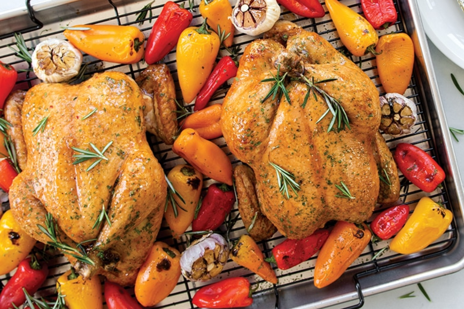 Two baked chickens and peppers on a Extra Large Oven Crisp Baking Tray.