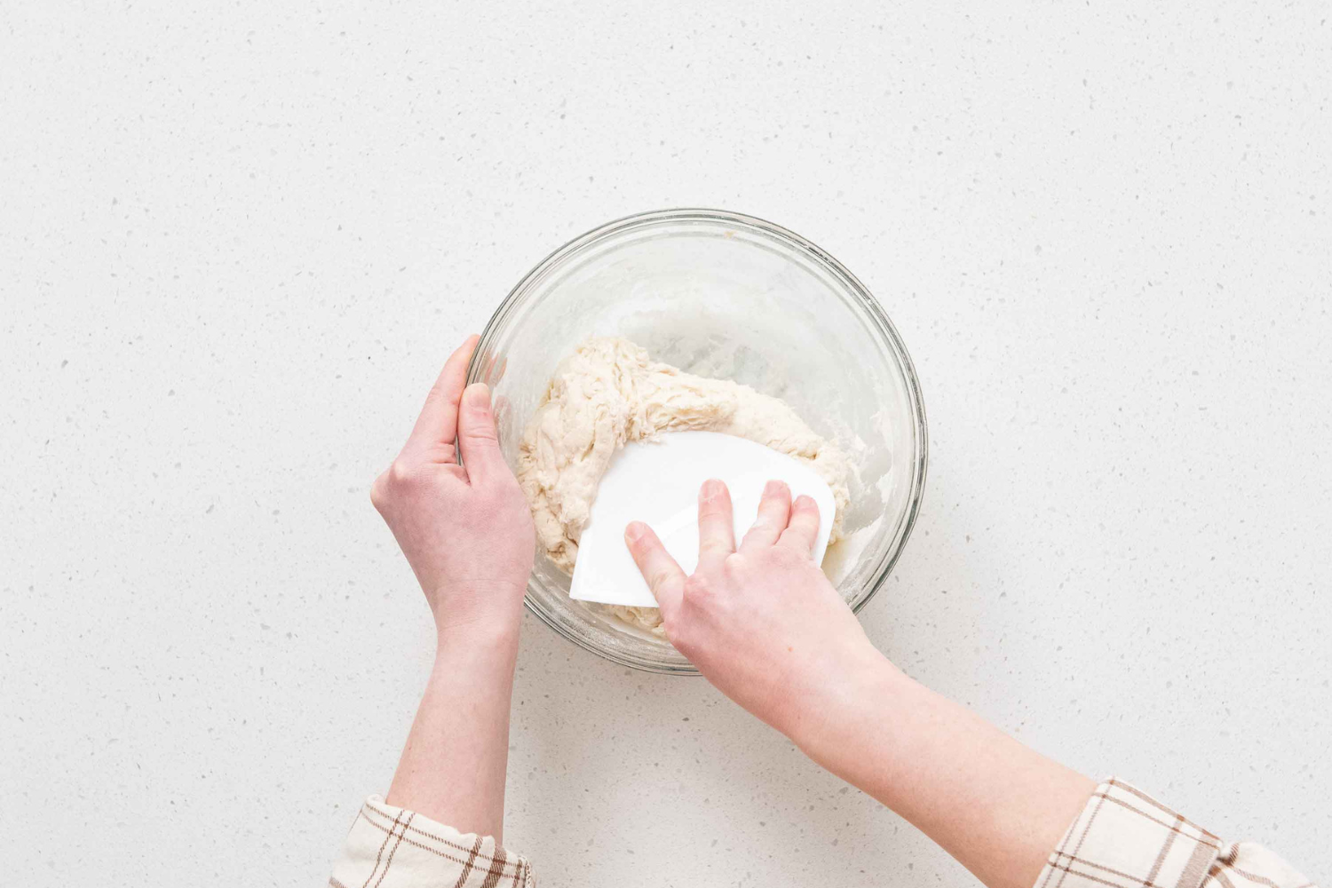 Hand folding and scraping sourdough bread dough with the Plastic Bench Scraper from the Simply Sourdough Bread Baking Kit. 