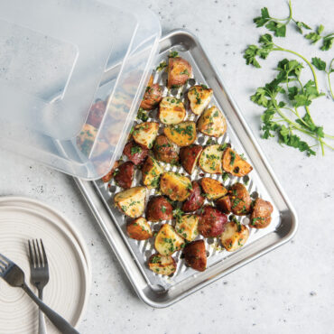 quarter sheet with multi task cooling rack and lid, roasted potatoes on rack